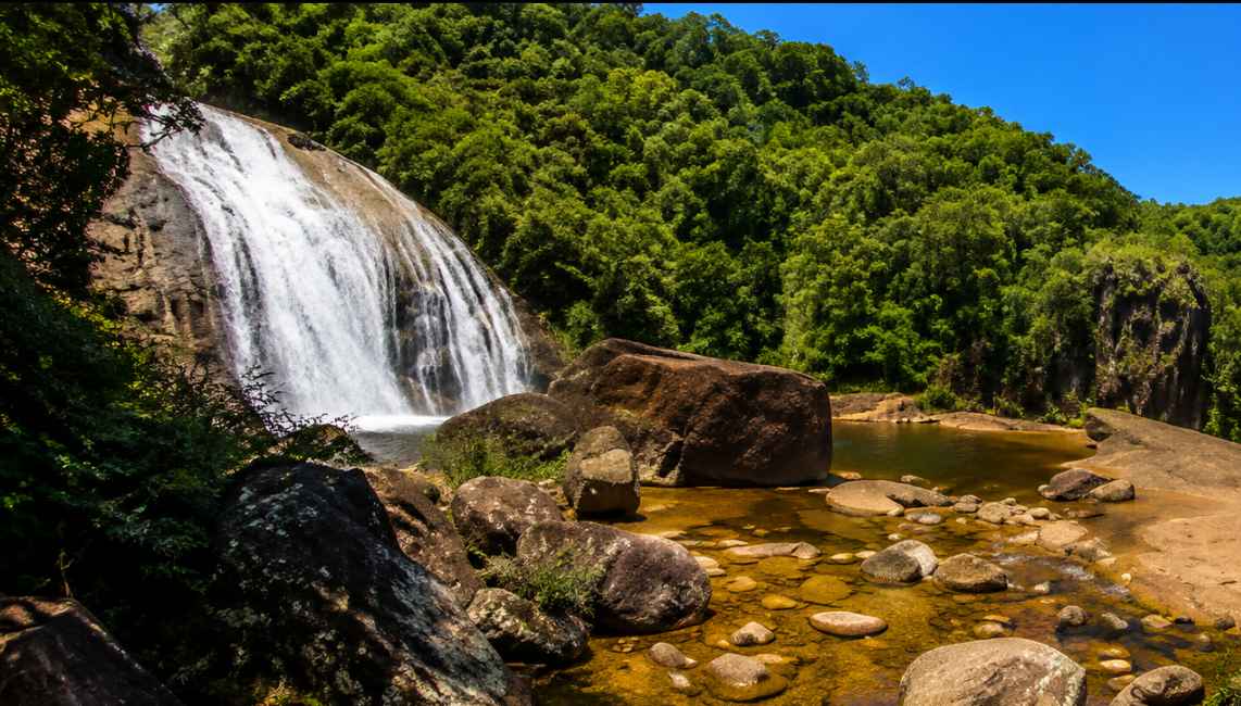 Waterfall and natural pool in the forested hills near Santo Amaro da Imperatriz